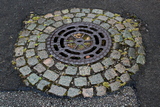 River Street, Derby - Circular cast iron drain with surround of granite setts.