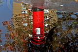 Pillar box reflection in flood water on River Street, Derby - November 2021.