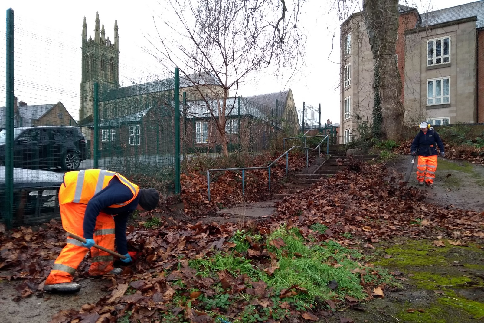 Workers from Derby Council's Streetpride clearing the steps into the green - February 2022